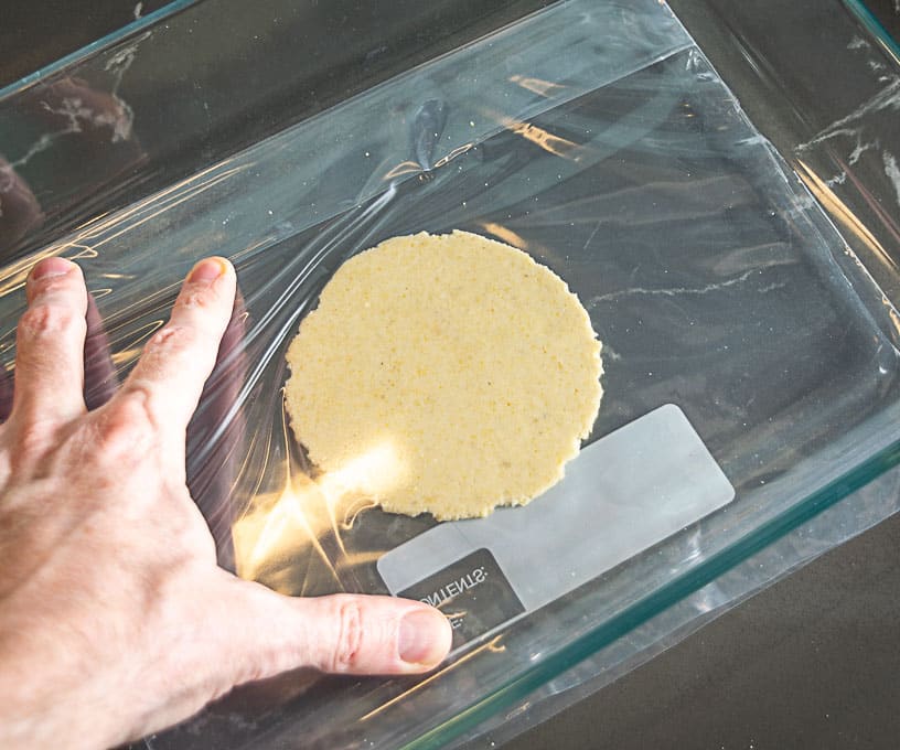 Flattening the dough ball with a casserole dish