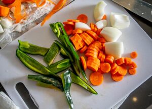 Chopping up carrots, onion and poblano chile for the roasting pan