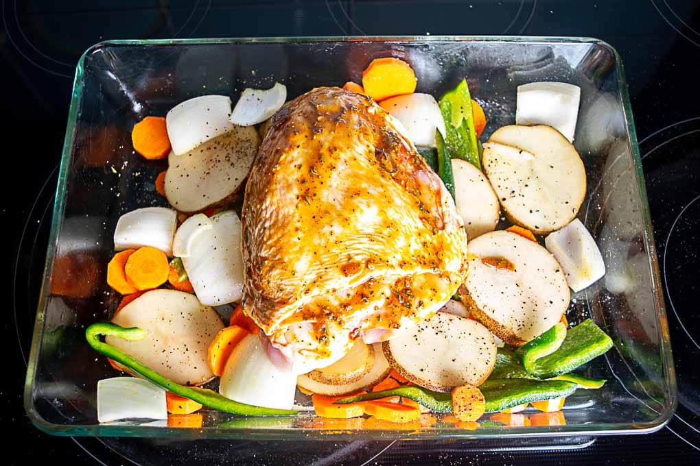 Adding spice rub to the bone-in chicken breast