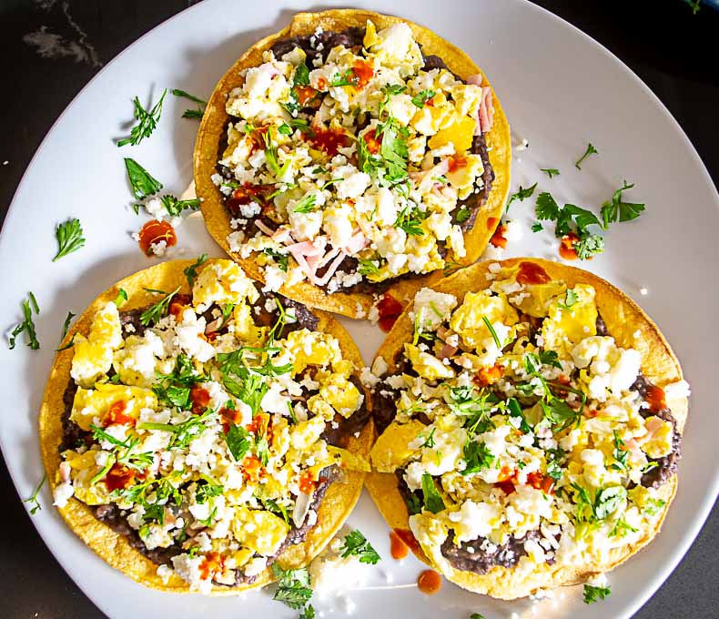 Plate full of bean and egg tostadas