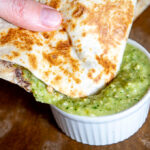 Dipping the quesadilla in the avocado salsa verde