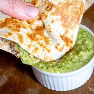 Dipping the quesadilla in the avocado salsa verde