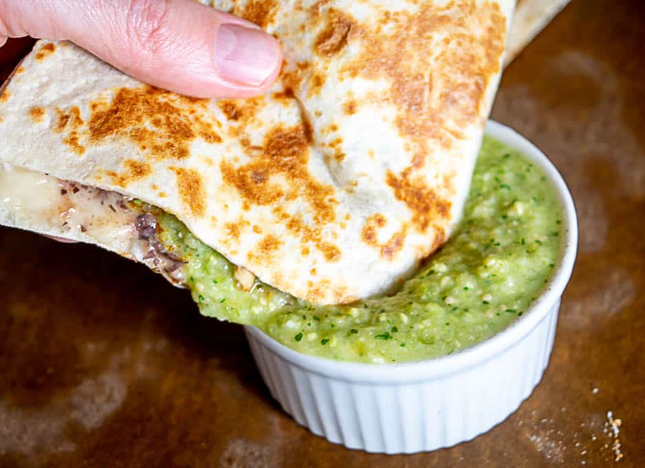 Dipping the quesadilla in the avocado salsa verde