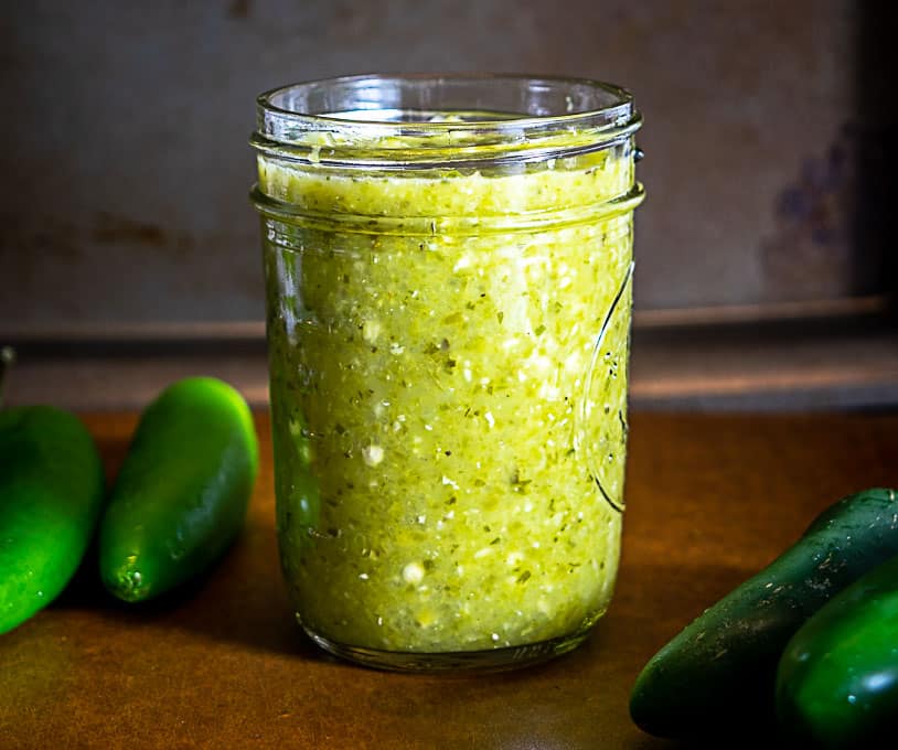 Adding the Serrano Jalapeno hot sauce to a small 8 oz. jar