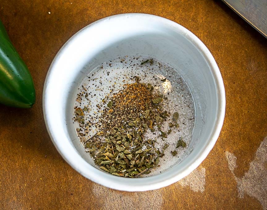 ramekin full of mexican oregano, cumin, black pepper, salt for the hot sauce