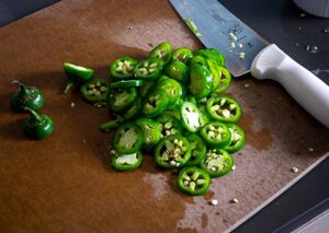 Slicing jalapenos into nickel sized slices