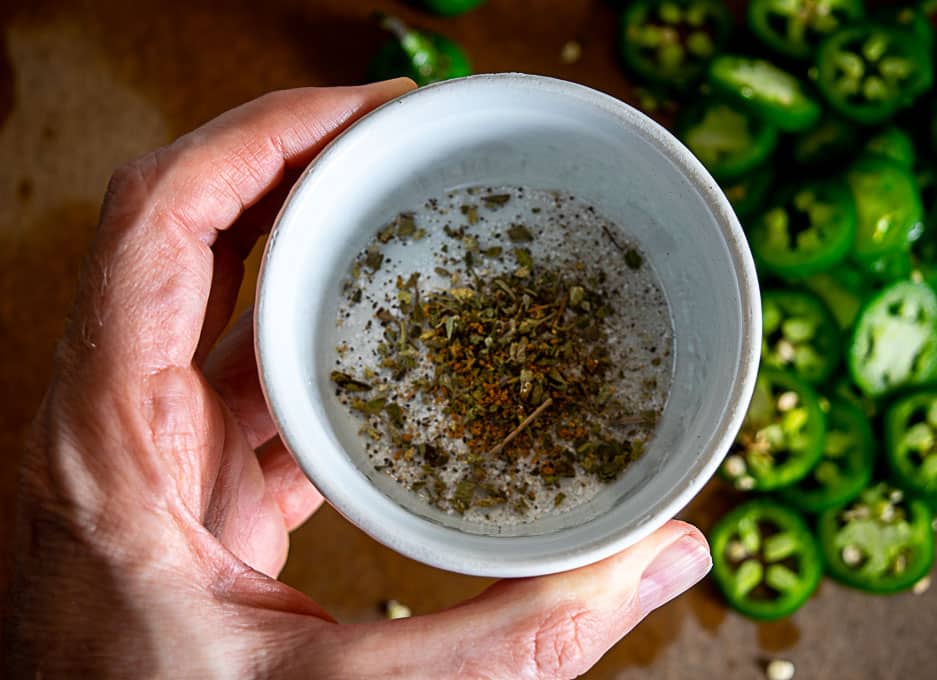 Adding the spices to a ramekin