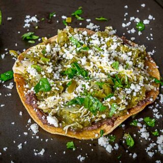 Squeezing lime on chicken chile verde tostadas