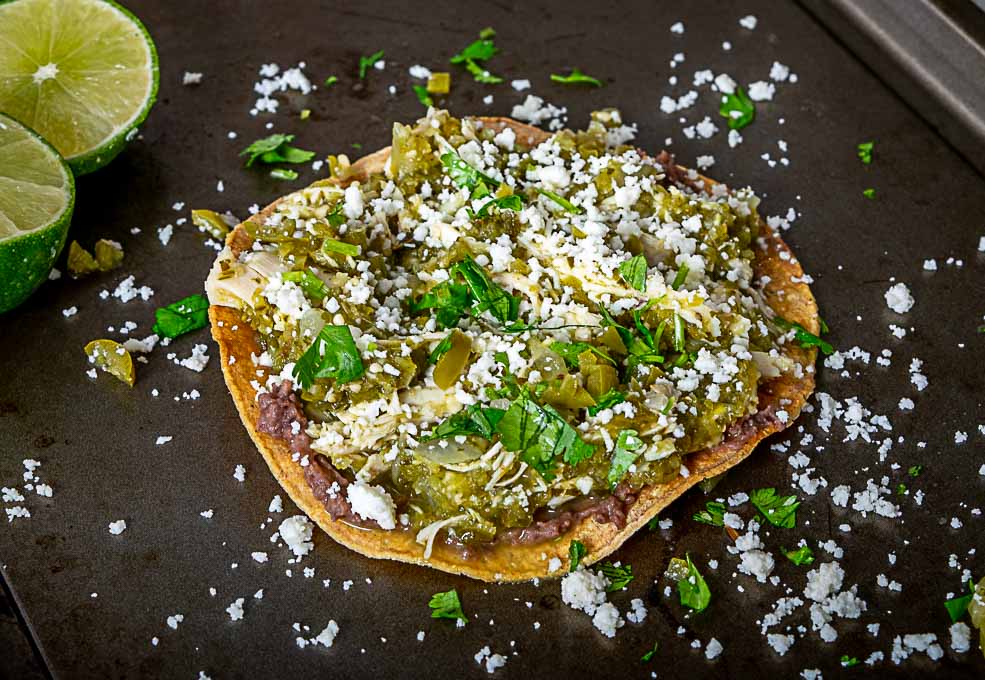 Squeezing lime on chicken chile verde tostadas