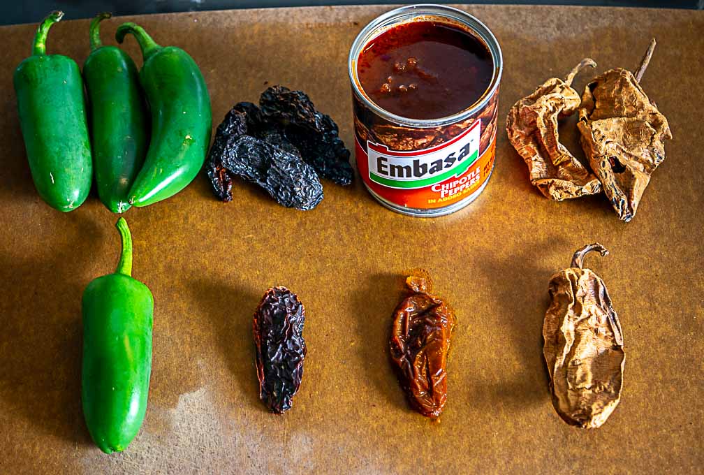 Showing all of the chiles next to each other: jalapeno, morita, chipotle in adobo meco