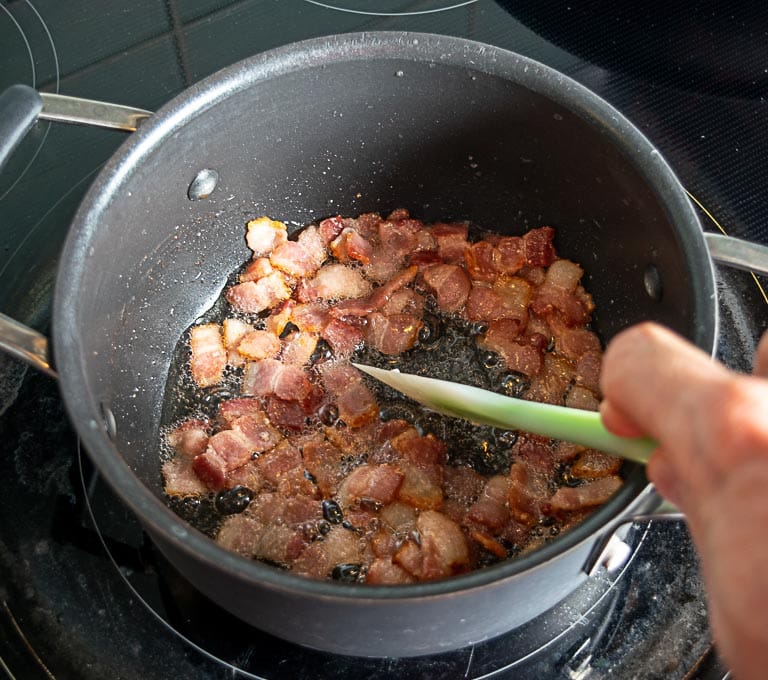 Cooking 4 slices of bacon over medium heat. 