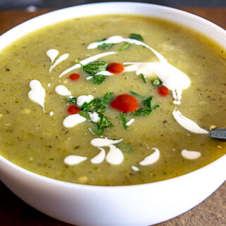 Bowl of Roasted Jalapeno Soup with cilantro, crema, and hot sauce