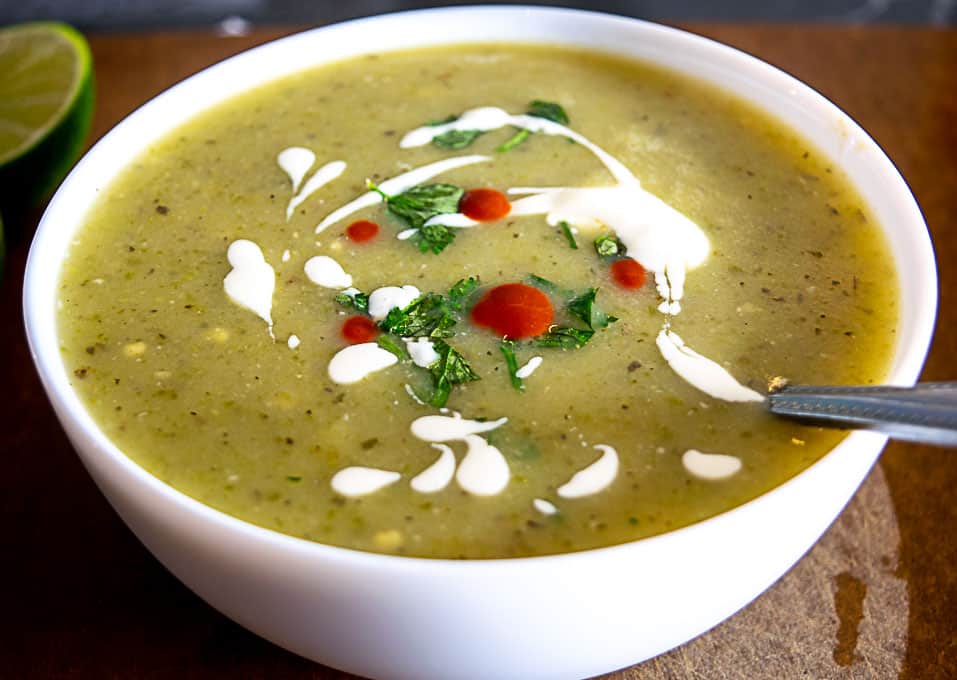 Bowl of Roasted Jalapeno Soup with cilantro, crema, and hot sauce