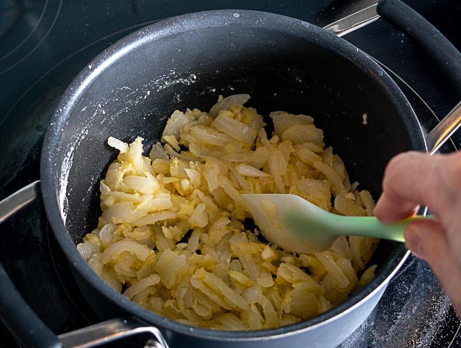 Adding three tablespoons flour to the onion garlic mixture