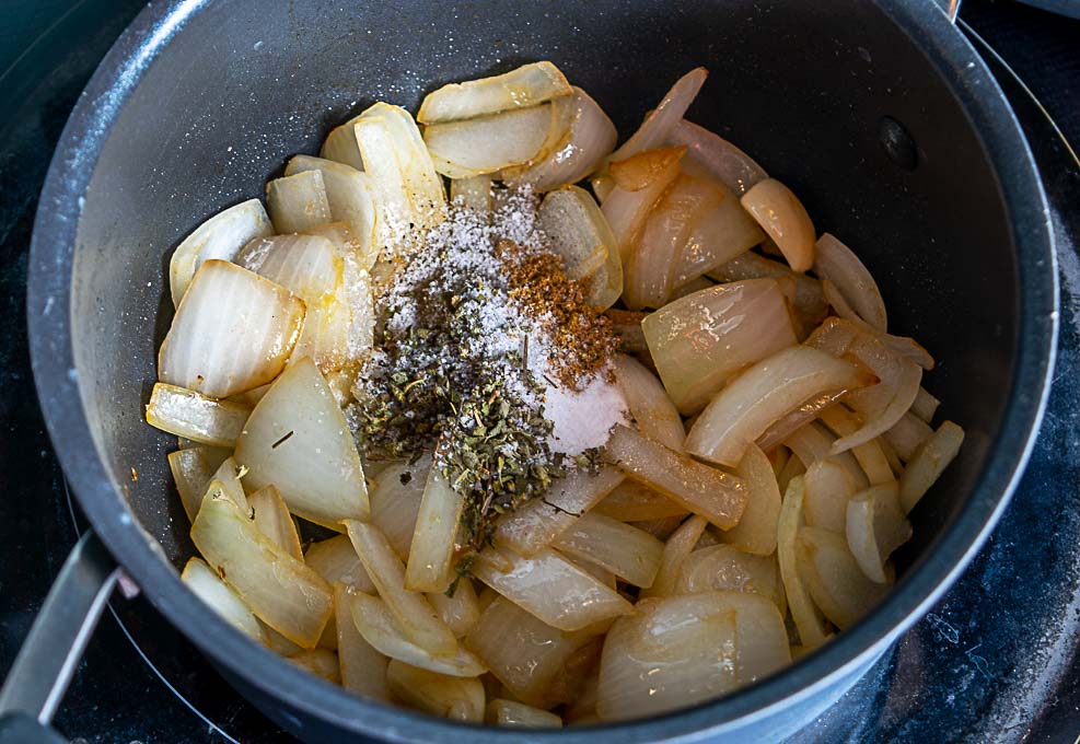 Adding Mexican oregano and cumin to the onion garlic mixture