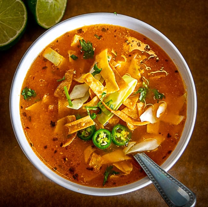 Adding final squeeze of lime to the tortilla soup