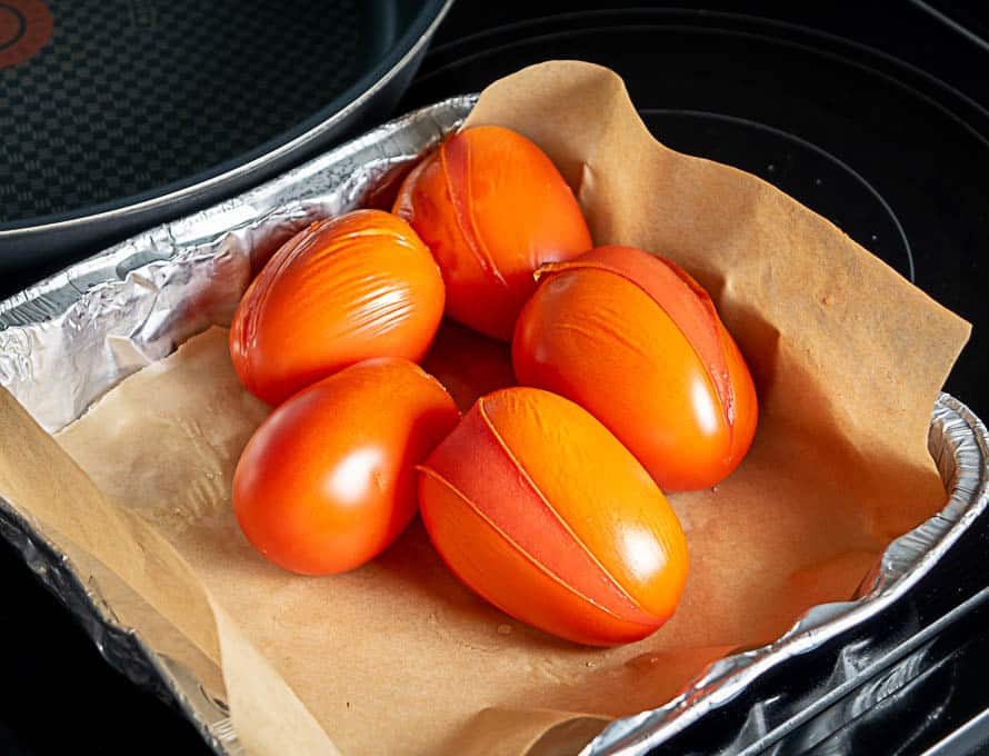 Roasting five plum tomatoes for the Vegetarian Tortilla Soup