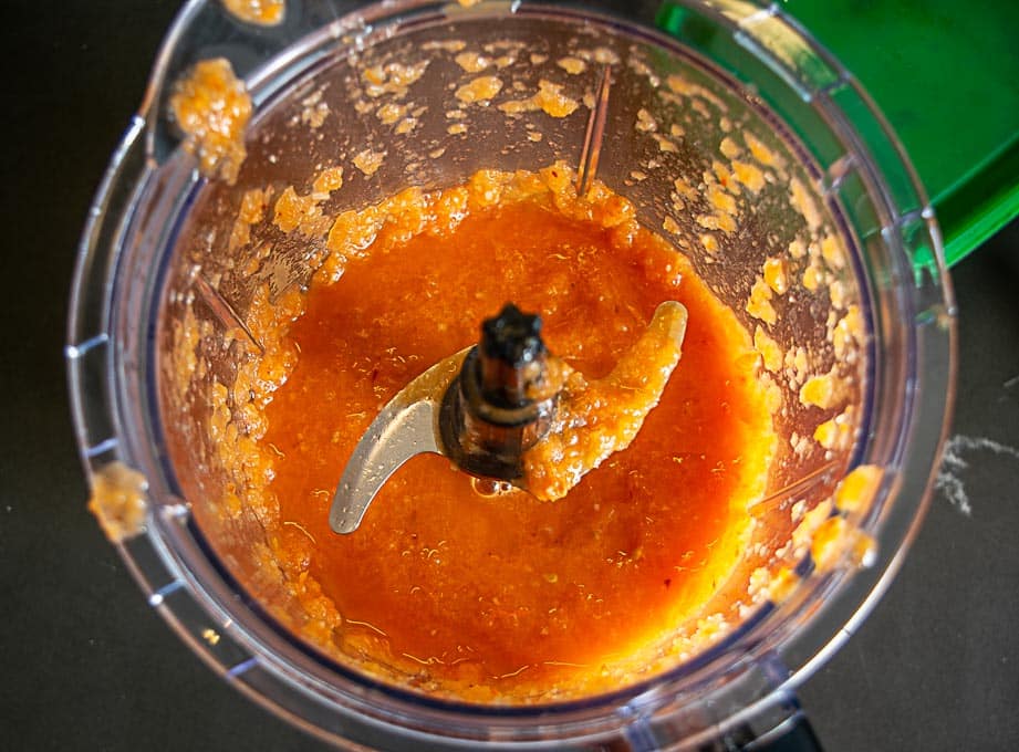 Combining the tomatoes and onion-garlic mixture in a blender
