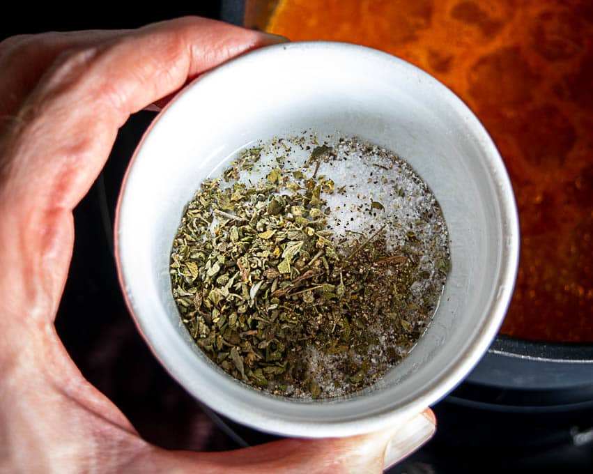 Adding the aromatics to the simmering broth