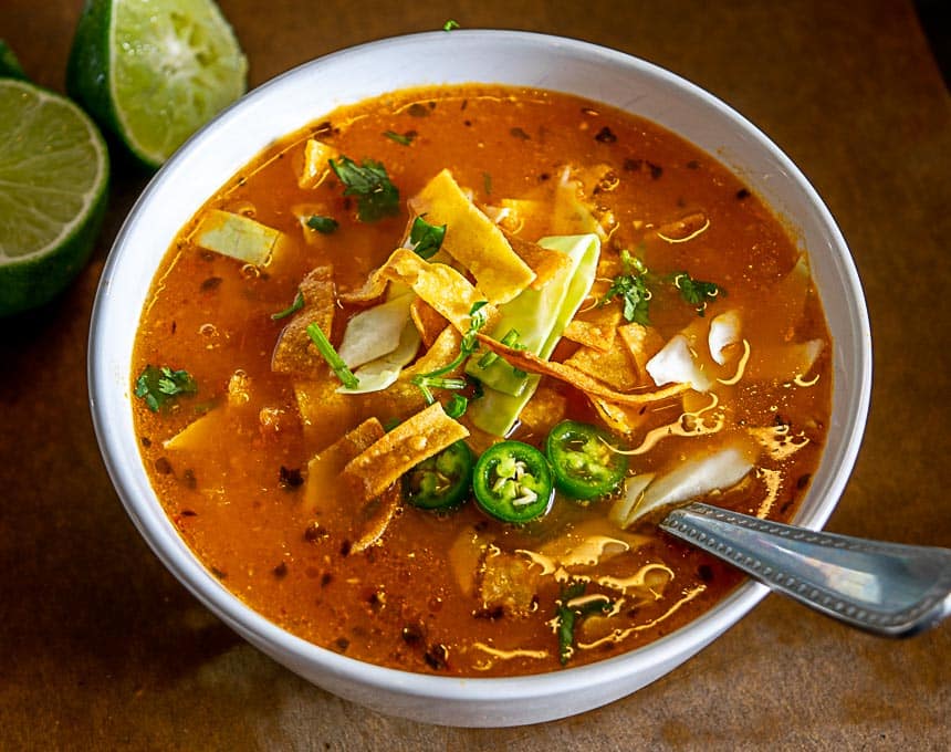 Adding the final garnish to the tortilla soup