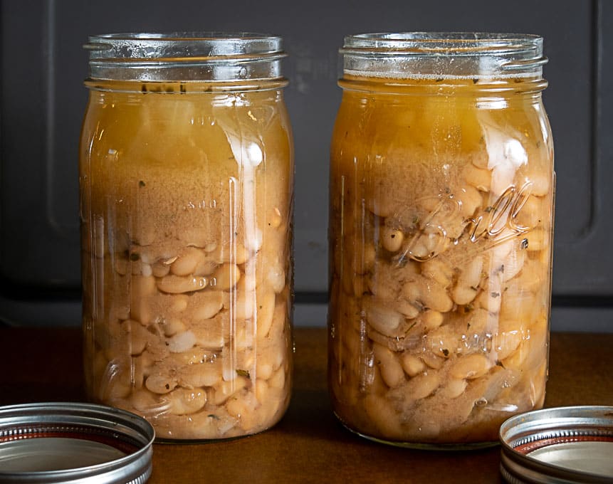 2 quart sized jars full of cooked Peruano beans