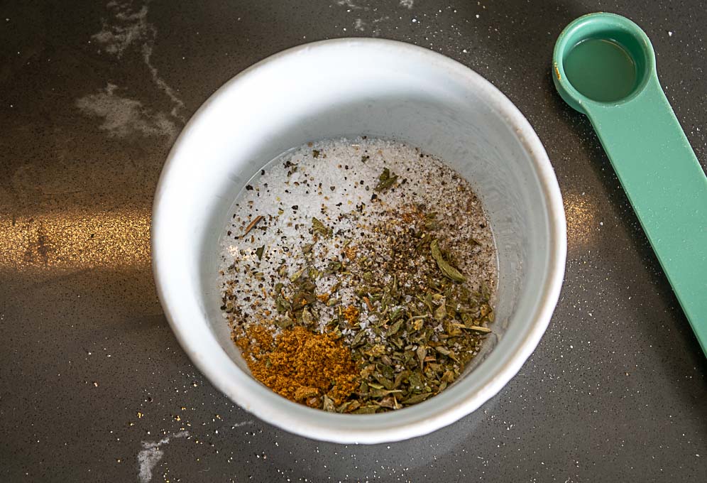 Adding Mexican oregano, cumin, salt, black pepper