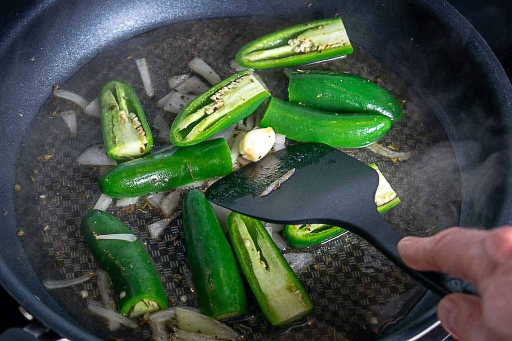 Simmering the jalapenos in vinegar and water