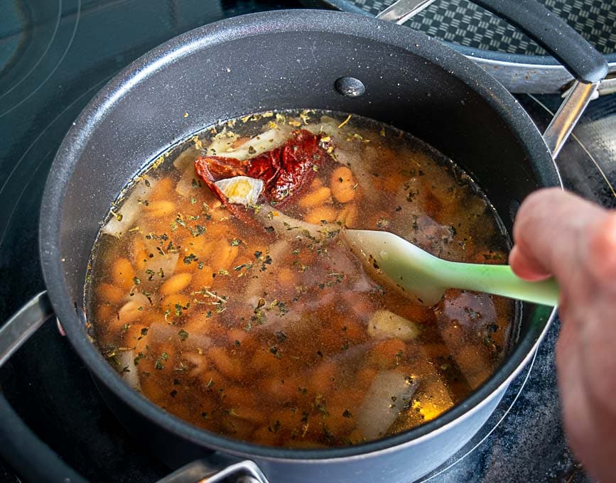 Adding beans and chipotle to the soup