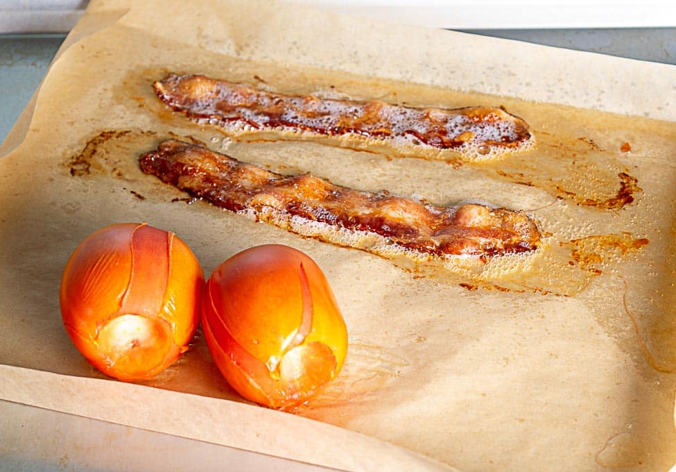 cooking bacon and tomatoes in the oven for the pinto bean soup