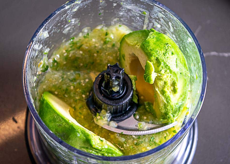 Adding avocado to the Salsa Verde