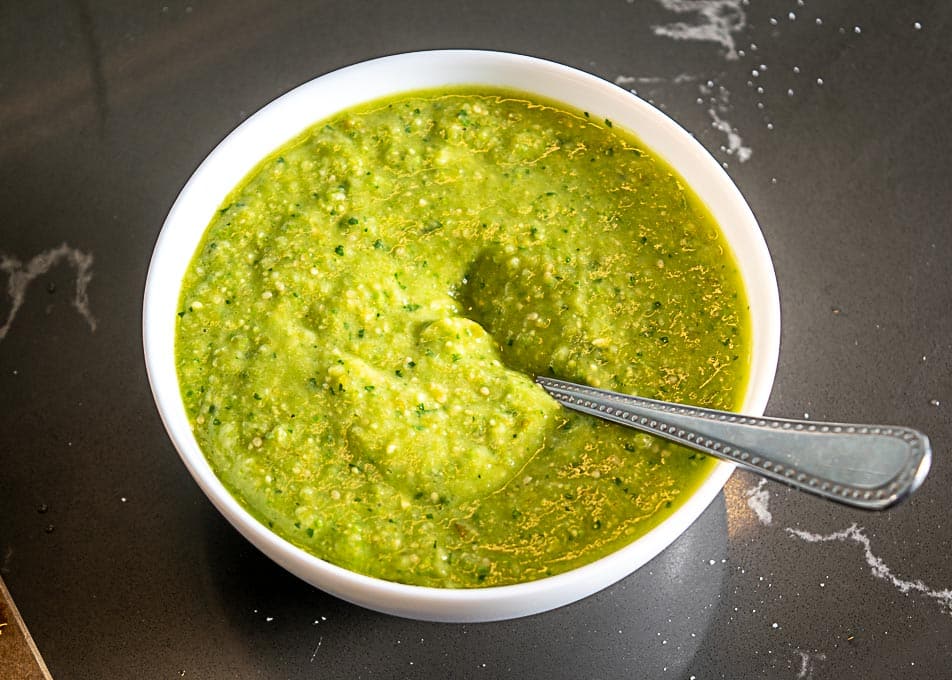 Adding the Avocado Salsa Verde to a bowl