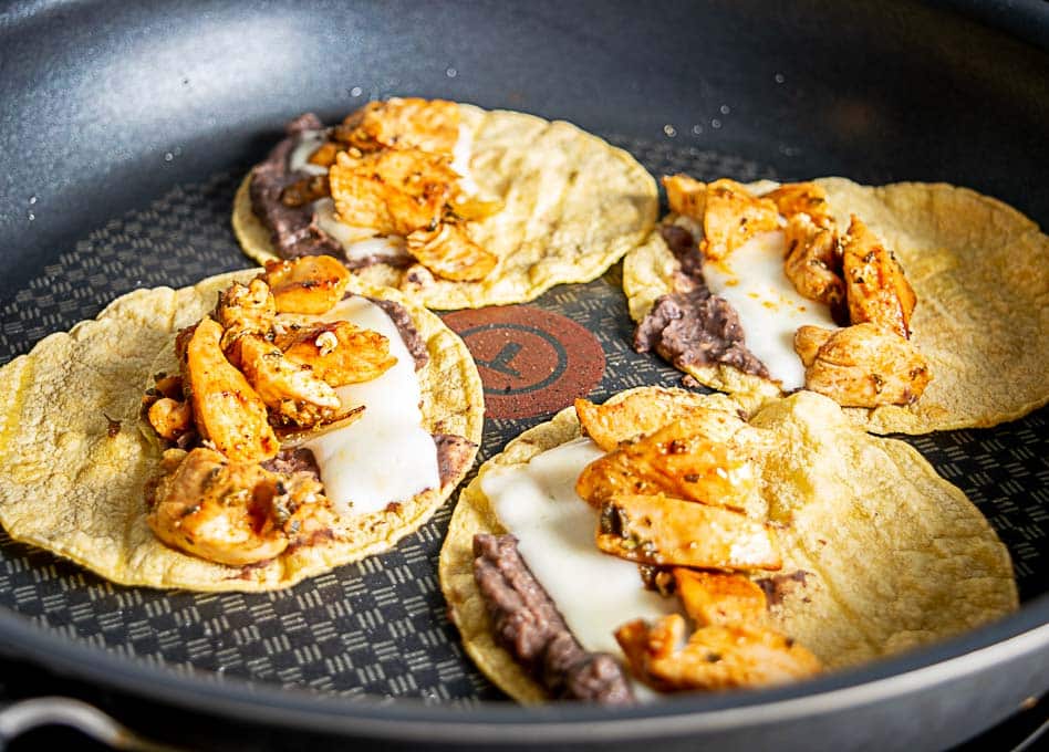 Chicken, cheese, refried beans on corn tortillas